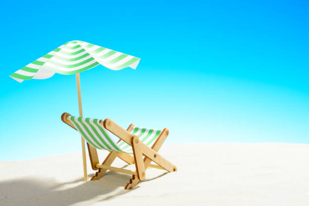 istock A chaise longue under an umbrella on the sandy beach, sky with copy space 930666876
