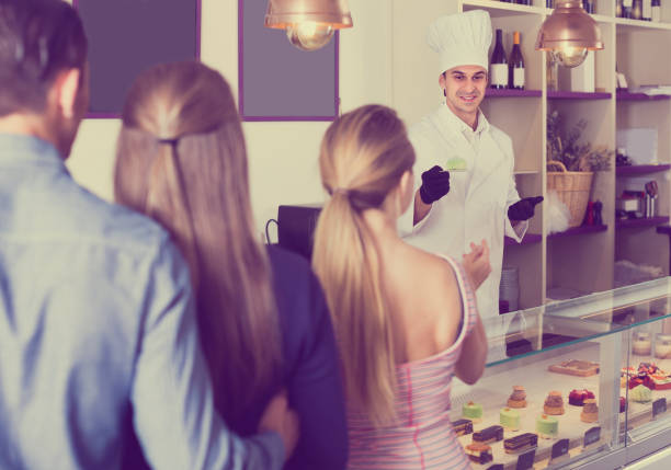 istock Man is offering delicious cakes from showcase 930667070