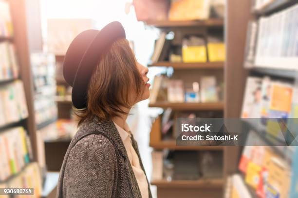 Young Woman Looking For Books In Store Stock Photo - Download Image Now - Bookstore, Bookshelf, Japanese Ethnicity