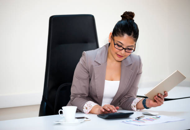 istock Businesswoman calculating the benefits by using calculator 930684194