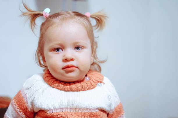 istock little girl standing at home 930684444