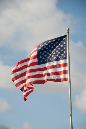 close up view of the american flag waving in the wind. Selective focus. Democracy, independence and election day. Patriotic symbol of American pride. Selective focus
