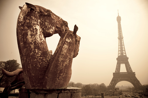 Eiffel tower and horse head statues in Trocadero - Paris. Sepia tone. Digital image taken with Canon EOS 5D MkII. Old Style treatment.