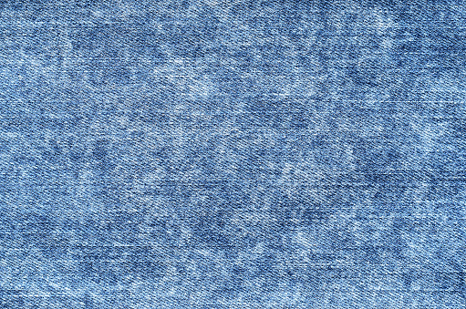 Jeans en azul ácido lavado. Fondo del dril de algodón de textura, de cerca. Lavado se desvaneció photo