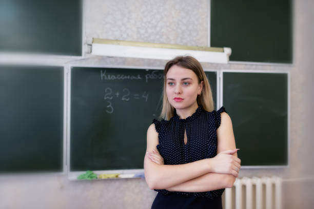 istock Strict young teacher blonde standing resting her hands on her hips 930697092