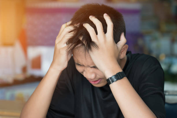 istock Education test concept : Asian boy student studying stressed headaches for exams in classroom, learning lessons doing final exam at high school. 930707944