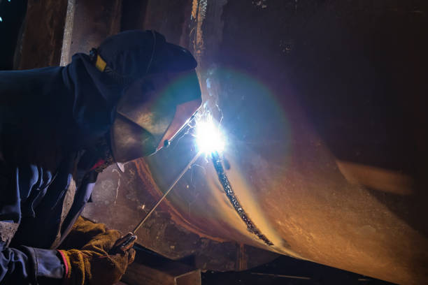 istock Welding works on metal  heat exchanger using manual arc welding 930711440