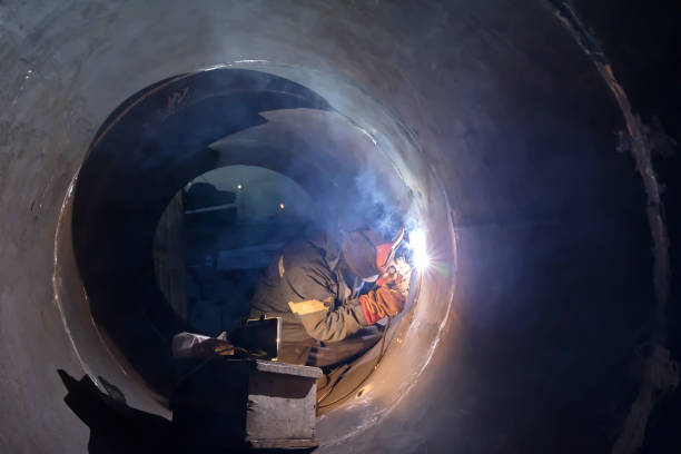 istock welder weld root weld from inside of big pipe 930711644