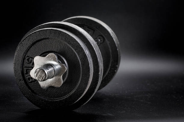 istock fitness concept - iron dumbbell abstract 930711840