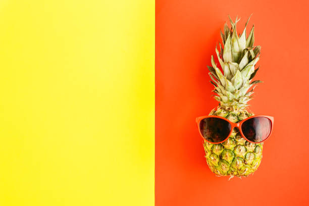istock Top view pineapple in sunglasses on colorful background. Flat lay. Summer Background concept 930712388