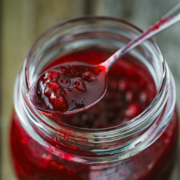 istock Traditional scandinavian jam with cowberry and juniper. Close-up. 930715698