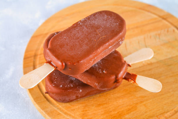 istock Ice cream on ice on a wooden board on a gray table. Eskimo. 930715882