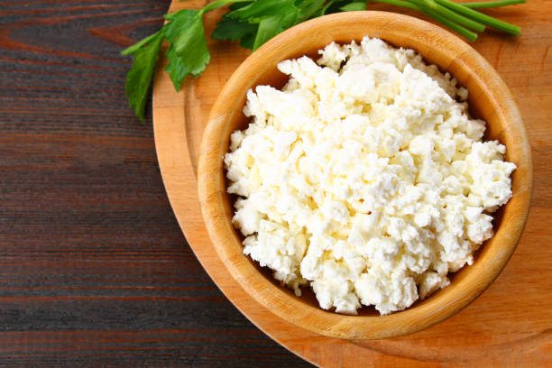 istock Home cottage cheese in a bowl on a wooden table. 930715912