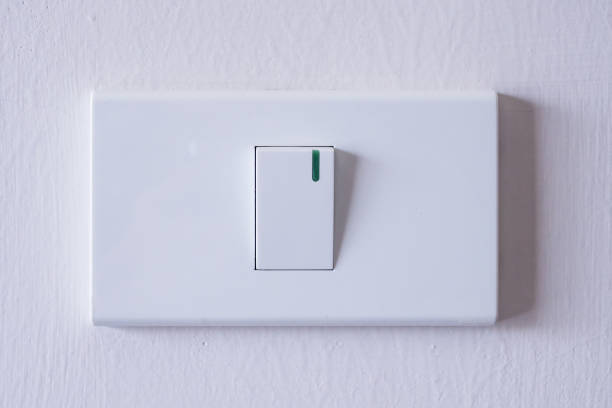 light switch on white concrete wall room light switch on white concrete wall dimmer switch photos stock pictures, royalty-free photos & images