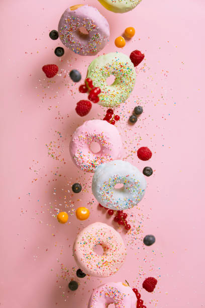 istock Sweet and colourful doughnuts falling or flying in motion 930716280