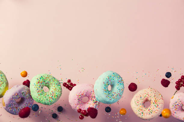 istock Sweet and colourful doughnuts falling or flying in motion 930716292