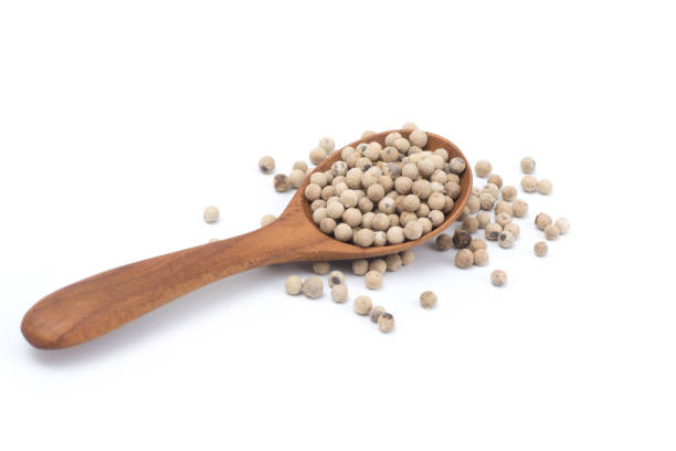 istock white  peppercorns on wooden spoon isolated on white background 930718688