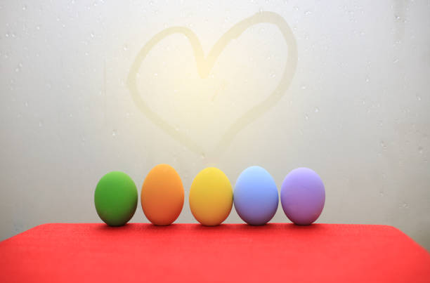 Two natural colored Easter eggs in hand with note saying LOVE