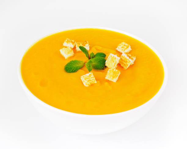 istock large white bowl with pumpkin puree soup on white background. Bright tasty dish, side view 930728548