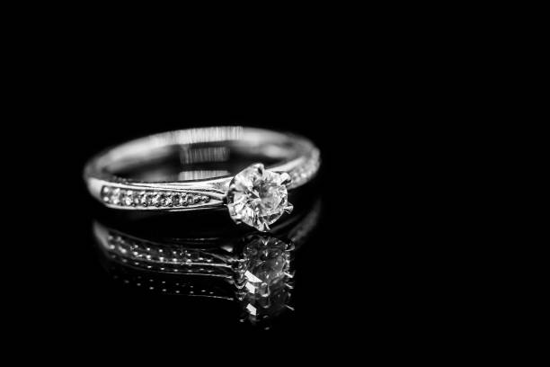 istock Close up Jewelry diamond ring on black background with reflection 930729322