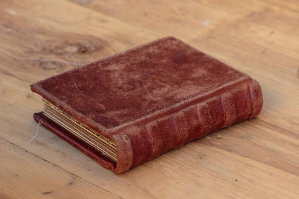 istock Antique Wrinkled Book on Wooden Plank 930730240