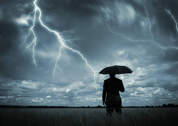 istock Man in black suit with a black umbrella in a storm 93073232