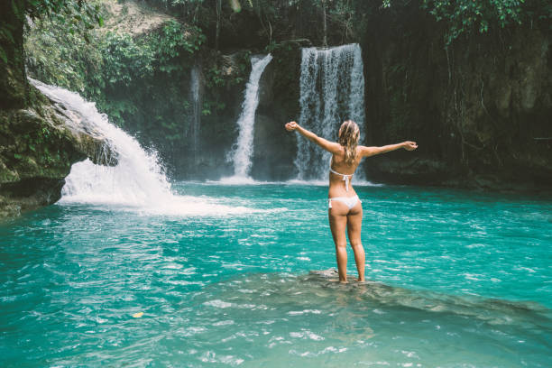 istock Girl embracing beautiful waterfall in the Philippines 930733080