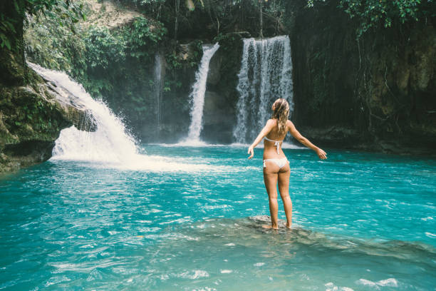 istock Girl embracing beautiful waterfall in the Philippines 930733394