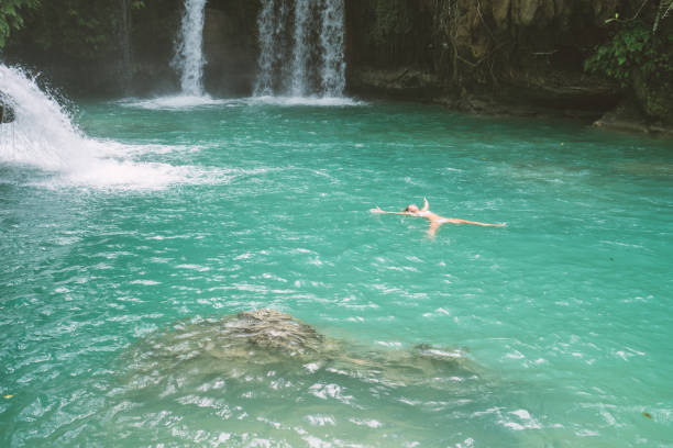 istock Girl floating in pool starfish pose 930733610