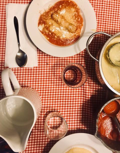 Classic italian food and table with checkered tablecloth