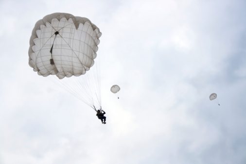 Skydivers falls through the air. Parachuting is fun!