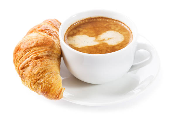 istock cup of coffee and croissant on white background 930740820