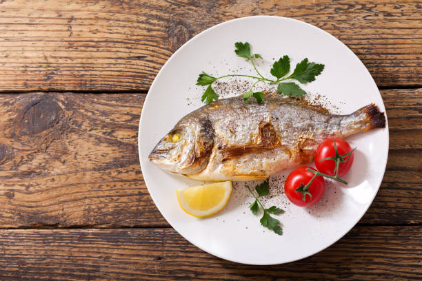 istock plate of baked fish with vegetables 930740842