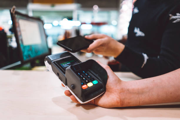 istock Cashier at boutique taking credit card from customer 930743896