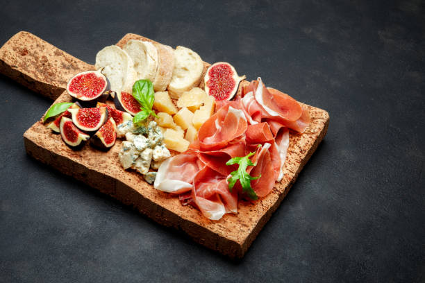 istock Italian prosciutto crudo or spanish jamon, cheese, figs and bread 930757984