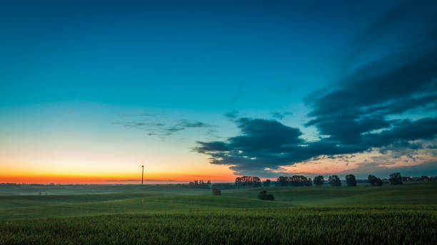 istock Dusk over field wind turbines in summer, Poland 930758594