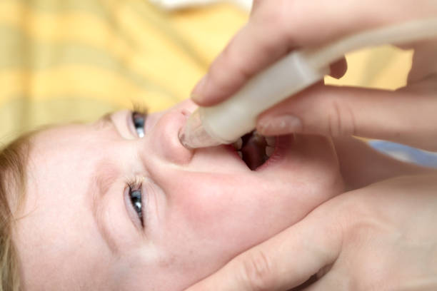istock Mother using child nasal aspirato 930759204