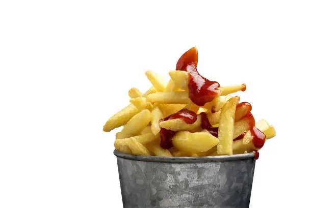 Photo of French fries in a metal pail on a white background