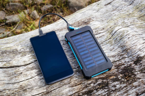 istock Smartphone charging with pink power bank on wood background 930768264