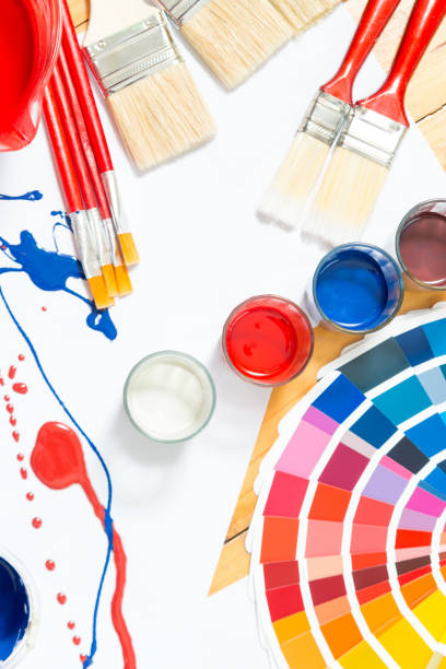 istock Painter and decorator work table with house project,level,saw,color swatches and paint roller top view. 930772118