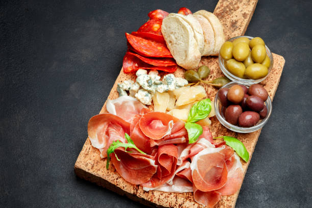 istock Italian prosciutto crudo or spanish jamon, cheese, olives and bread 930776324