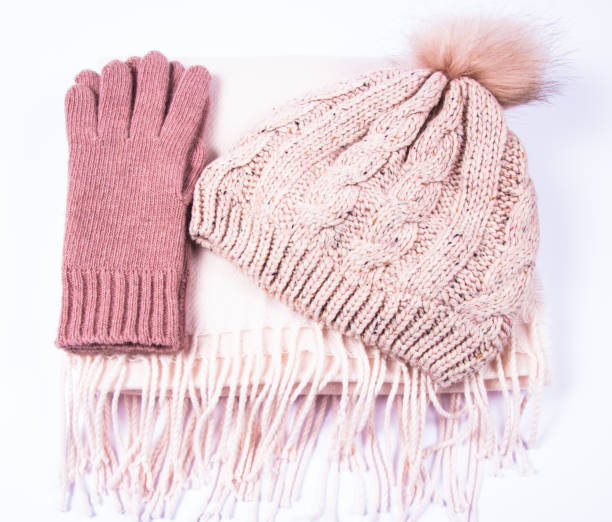 istock Warm winter knitted clothes - hat, scarf, gloves on a white background. 930776514