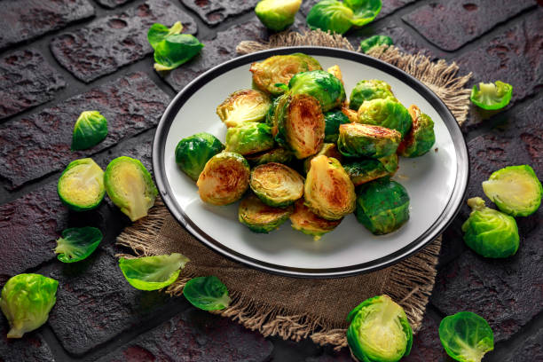 istock Homemade Roasted Brussel Sprouts with Salt, Pepper on a old stone rustic table 930776808