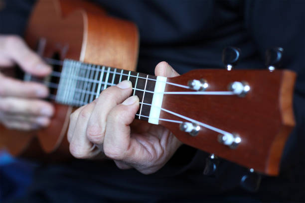 istock close up ukulele in musician hands 930777338