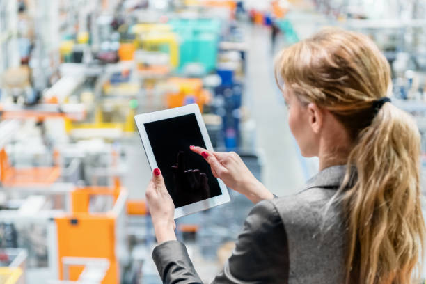 istock Woman in plastic factory working with tablet 930780452