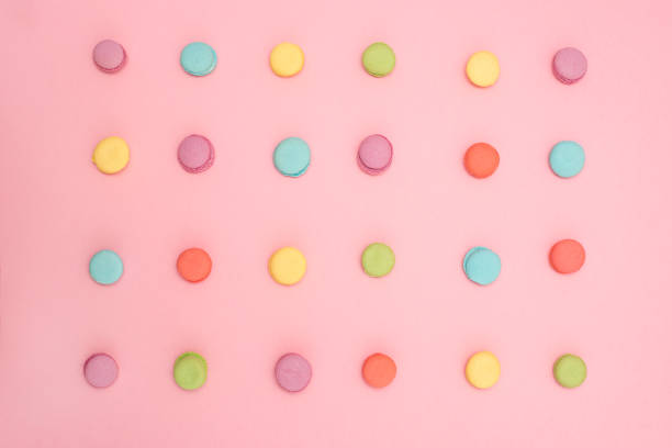 istock Multicolored macaroons in a row on pink background 930780828