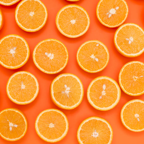 istock Background from the oranges cut in half on an orange background 930784316