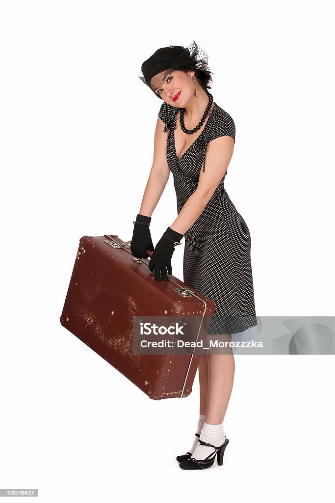 Mujer sonriente con una maleta pesadas - Foto de stock de Adulto libre de derechos
