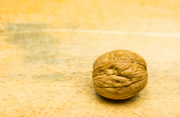 istock Whole walnut on a wooden background. 930789458