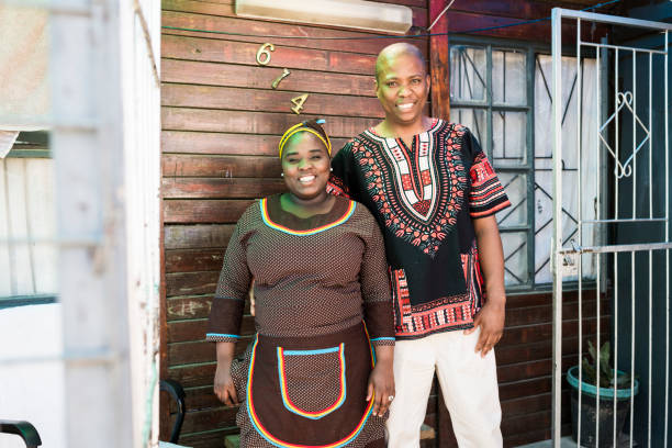 istock Husband and wife standing outside their home 930792944